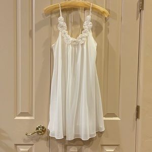White flowy dress with flower trim on neck
